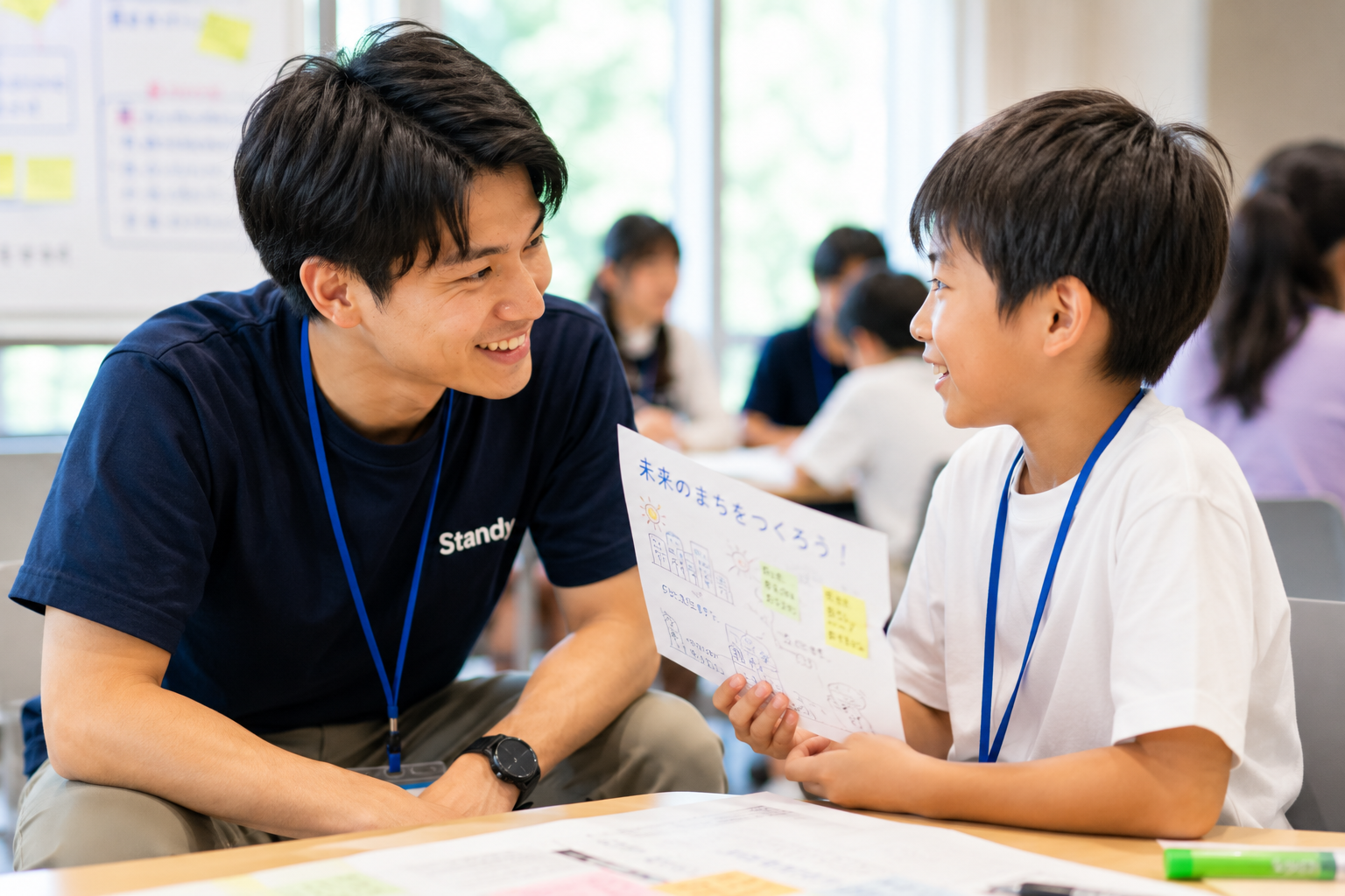神戸大学生が小学生と1対1で向き合い、真剣に話を聞いている様子